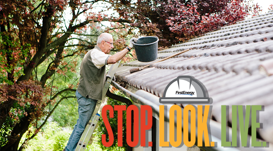 Elderly Man Stands On Ladder Cleaning Gutter