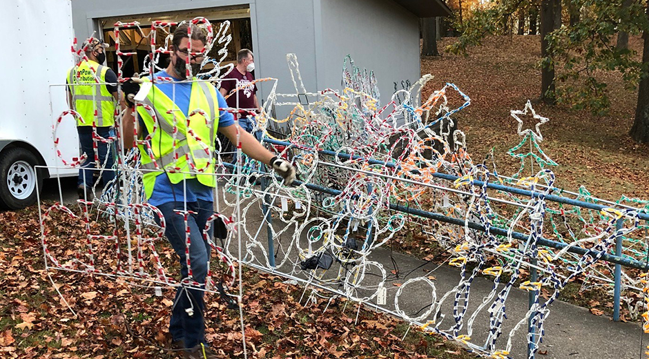 Mon Power Volunteers Carry Christmas Lights