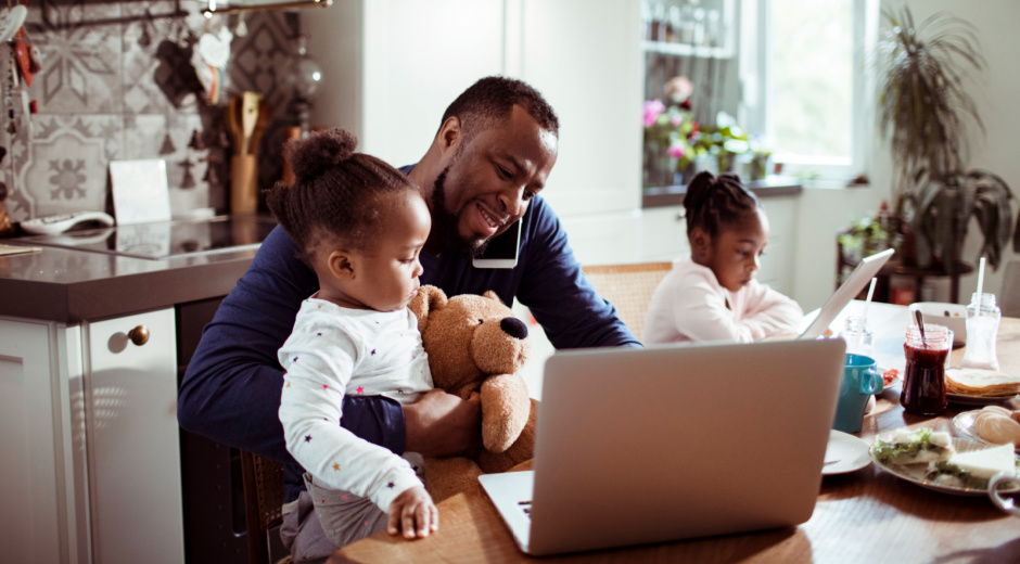 Family using laptop at breakfast