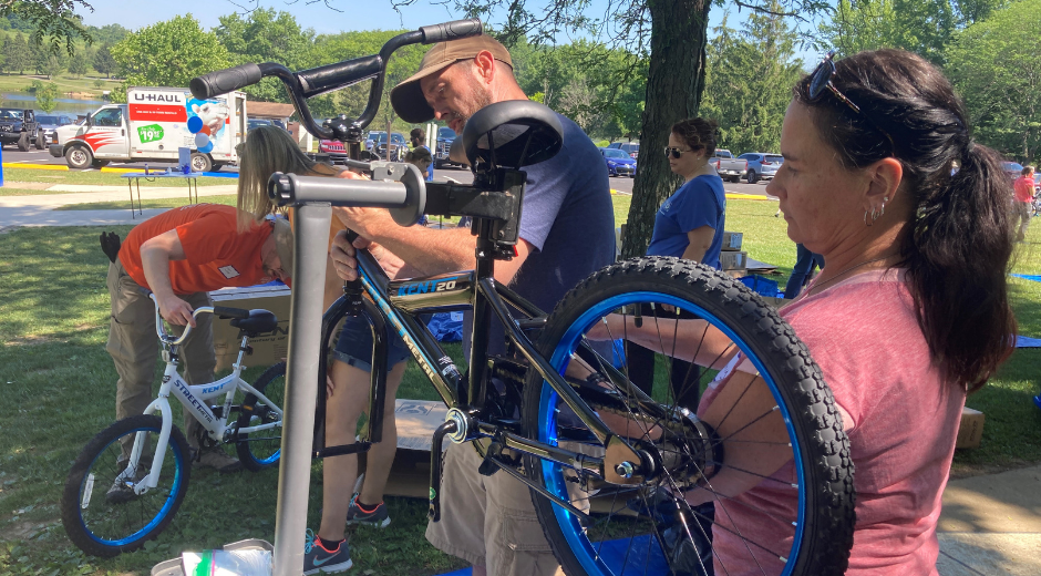 adults building a bike
