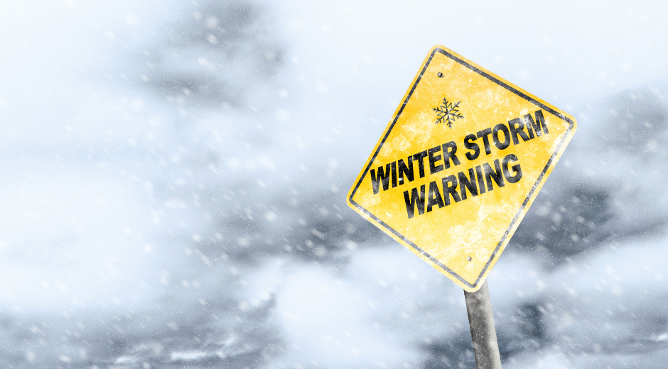 Winter storm warning sign in a blizzard